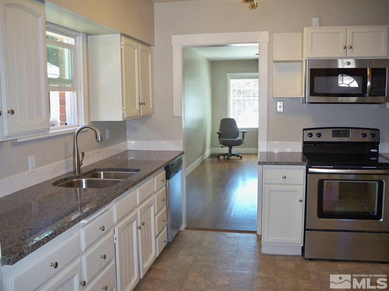 944 9441/2 Bell Street Reno, NV 89503 - Photo 1 of 1 a kitchen with stainless steel appliances granite countertop a sink stove and microwave