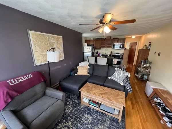 a living room with furniture a air conditioner and a window