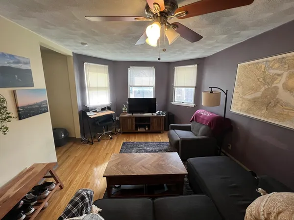a living room with furniture and a chandelier