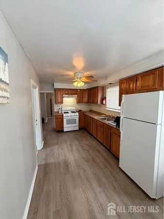 a kitchen with refrigerator and cabinets