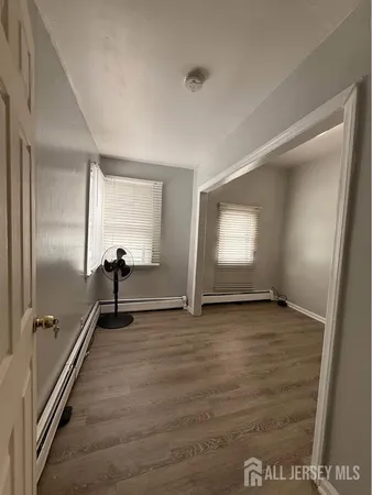 a view of a room with wooden floor and windows