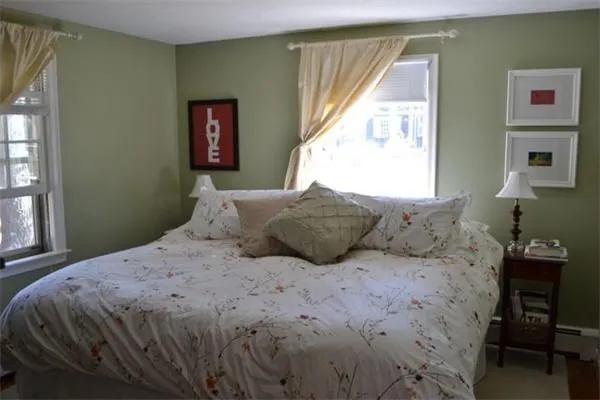 a bedroom with a large bed and a window