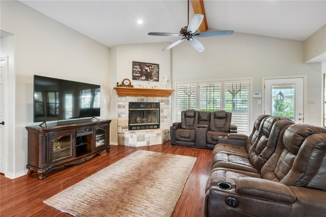 1152 McNutt Road Franklin, TX 77856 - Photo 11 of 38 a living room with furniture a flat screen tv and a fireplace
