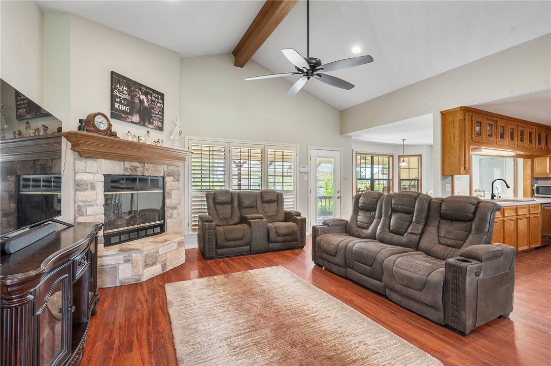 1152 McNutt Road Franklin, TX 77856 - Photo 12 of 38 a living room with furniture a flat screen tv and a fireplace