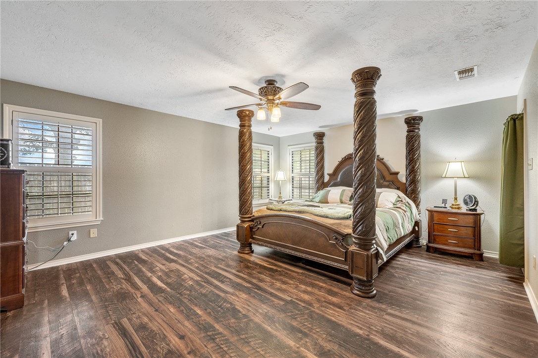 1152 McNutt Road Franklin, TX 77856 - Photo 18 of 38 a bedroom with a bed and a chandelier