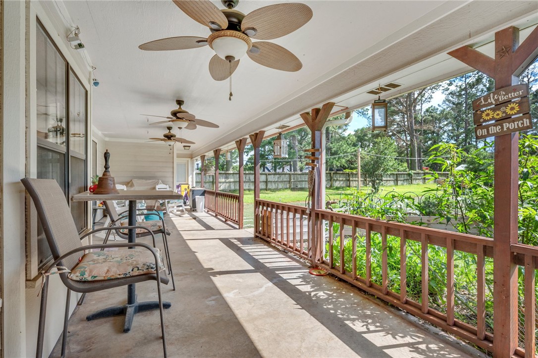 1152 McNutt Road Franklin, TX 77856 - Photo 20 of 38 a view of a porch with furniture and a floor to ceiling window