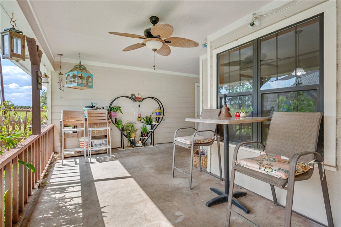1152 McNutt Road Franklin, TX 77856 - Photo 21 of 38 a living room with furniture a chandelier and a window
