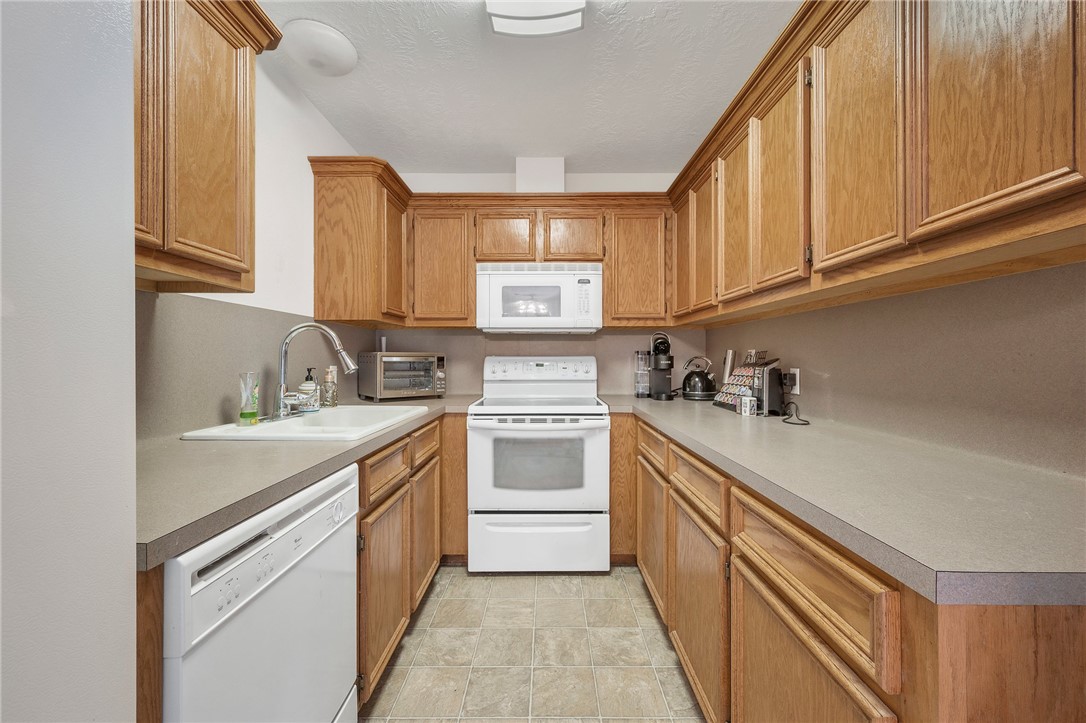 1152 McNutt Road Franklin, TX 77856 - Photo 22 of 38 a kitchen with stainless steel appliances granite countertop a sink and cabinets