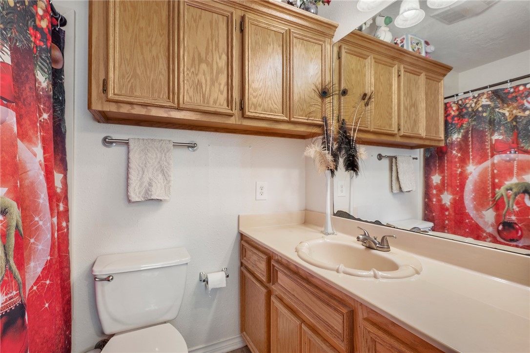 1152 McNutt Road Franklin, TX 77856 - Photo 26 of 38 a bathroom with a granite countertop sink a toilet and mirror