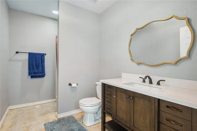 a view of a grassy field with trees in the background