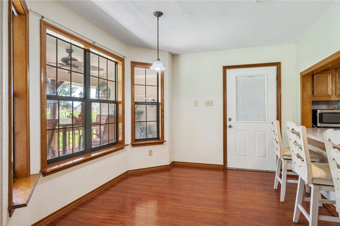 1152 McNutt Road Franklin, TX 77856 - Photo 9 of 38 a view of an empty room with a window and wooden floor