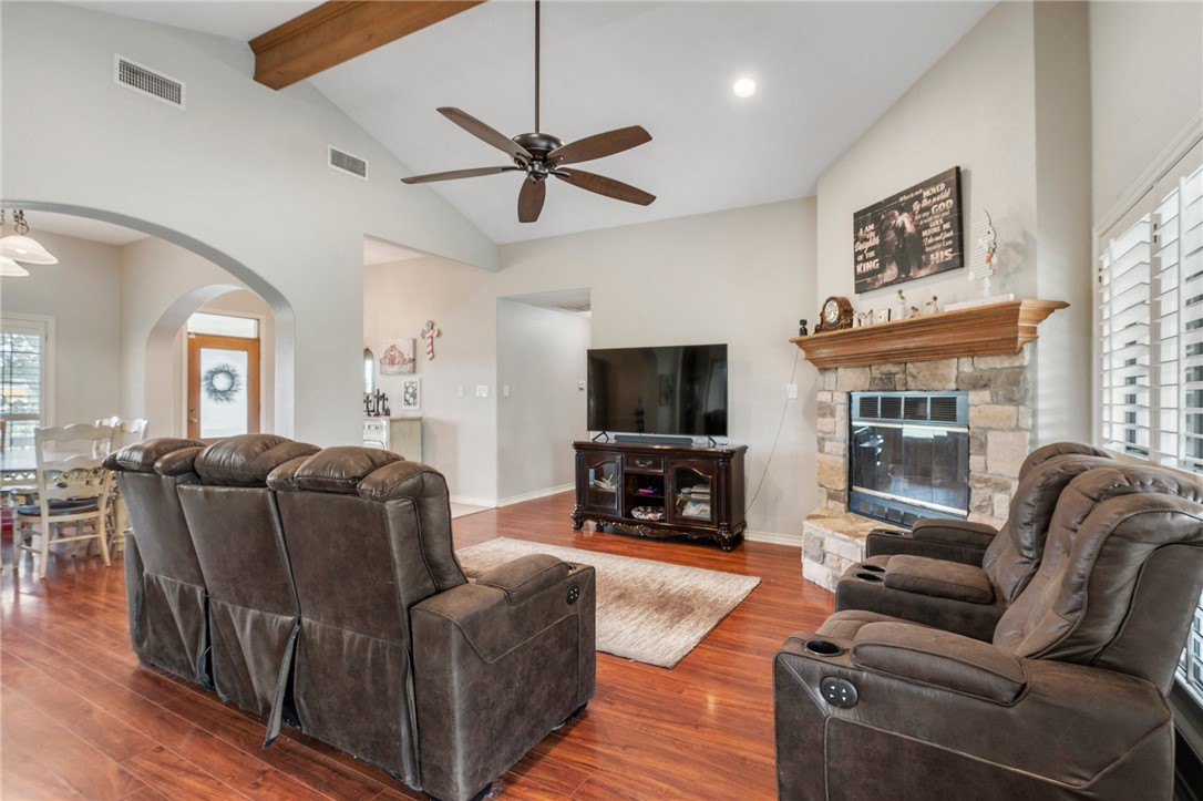 1152 McNutt Road Franklin, TX 77856 - Photo 10 of 38 a living room with furniture a flat screen tv and a fireplace