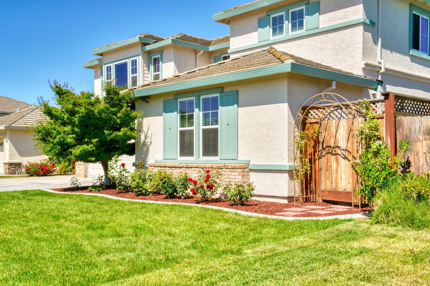 426 South Highland Avenue Ripon, CA 95366 - Photo 7 of 82 a front view of a house with a garden and plants