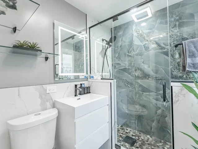 a bathroom with a sink toilet and shower