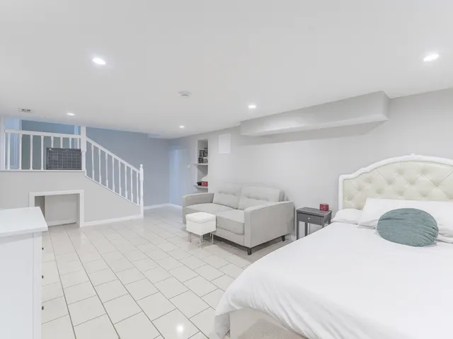 a spacious bedroom with two beds and a couch