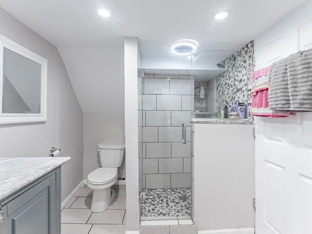 a bathroom with a sink toilet and shower