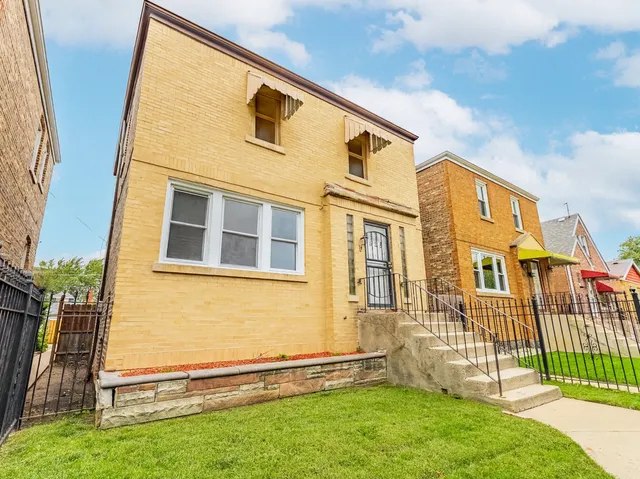 a view of a brick house with many windows
