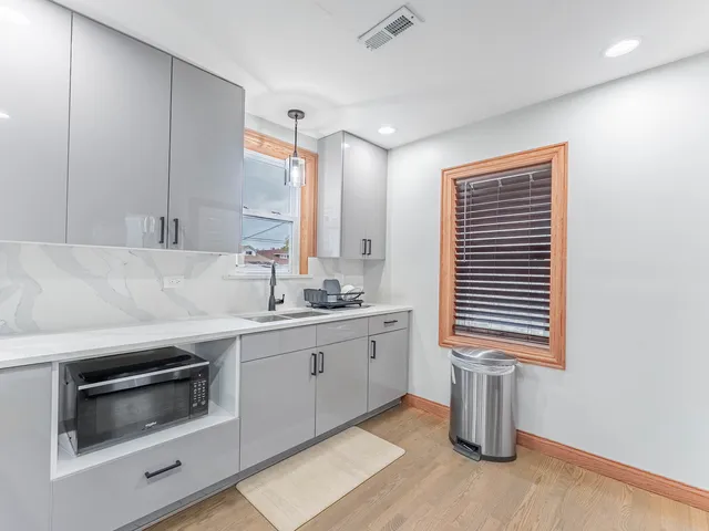a kitchen with sink and cabinets