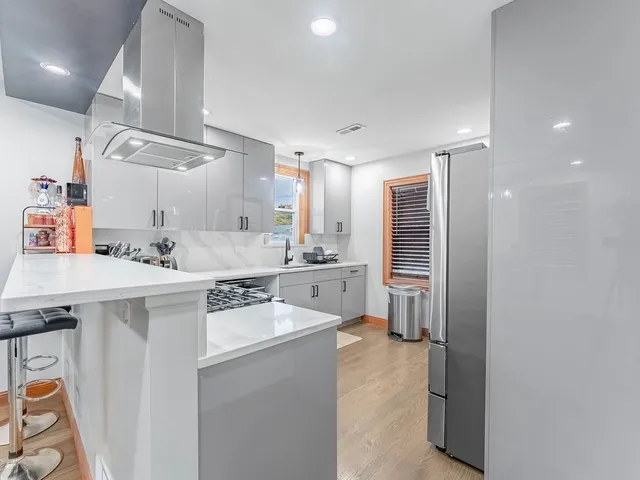 a kitchen with a sink appliances cabinets and a counter top space