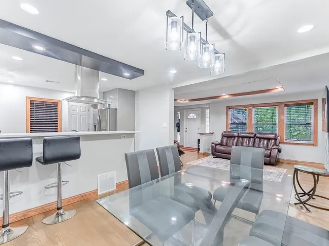 a living room with furniture and chandelier