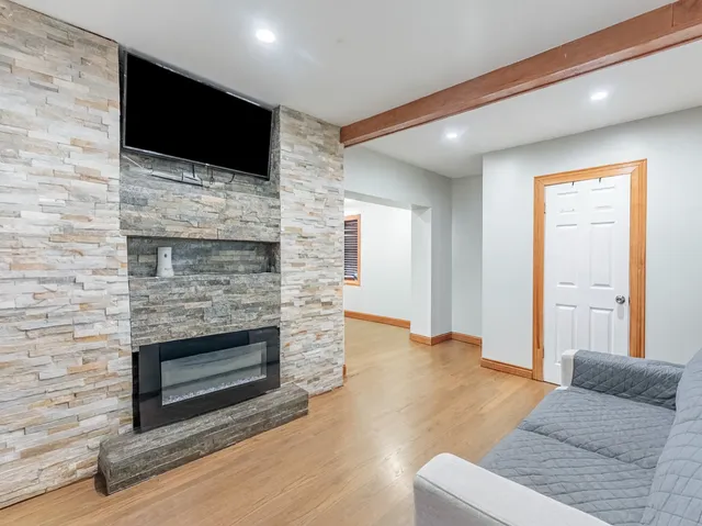 a living room with a fireplace furniture and a flat screen tv