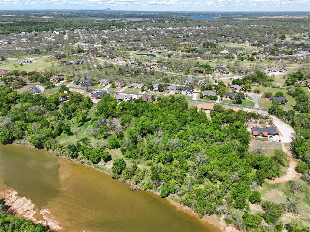 9804 Bellechase Road Granbury, TX 76049 - Photo 16 of 18 an aerial view of residential houses with outdoor space and trees
