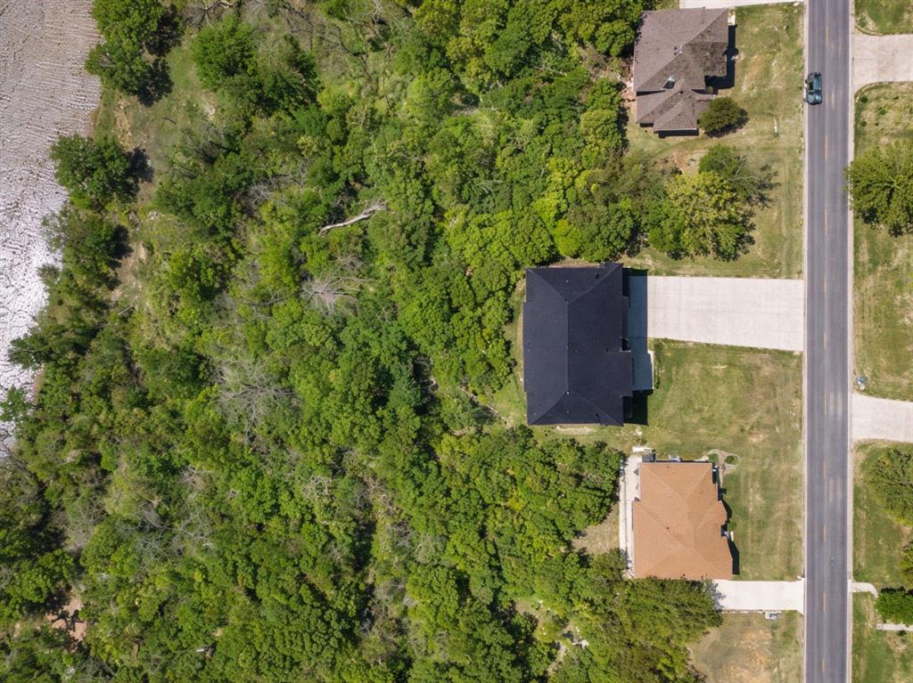 9804 Bellechase Road Granbury, TX 76049 - Photo 5 of 18 an aerial view of a house with a yard and large tree