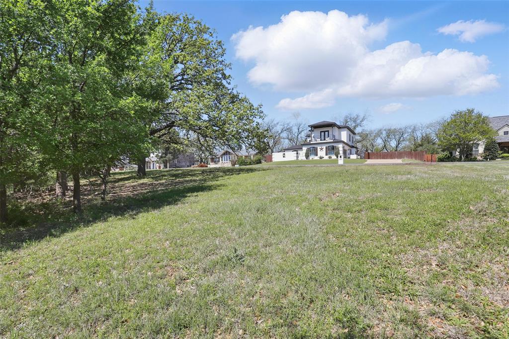9804 Bellechase Road Granbury, TX 76049 - Photo 8 of 18 a view of a field with large trees