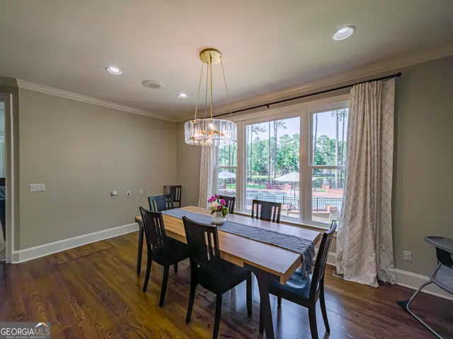 a spacious bedroom with a bed a couch and a chandelier