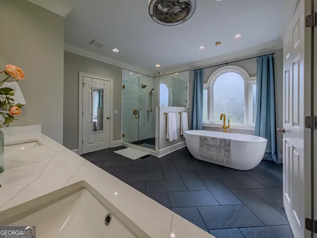 a bathroom with a sink a toilet a mirror and shower curtain