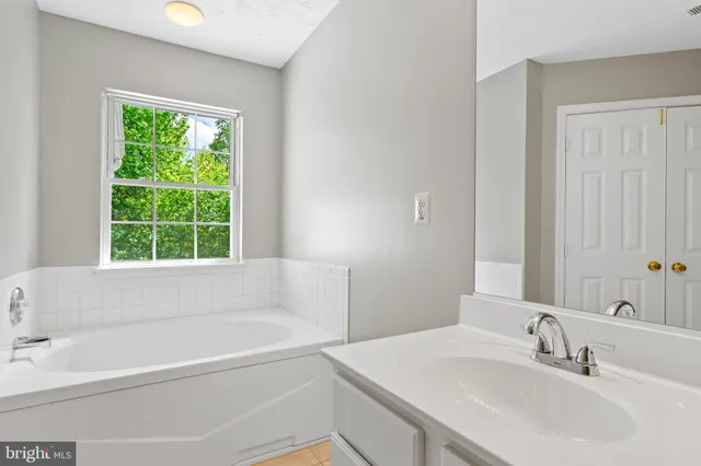 a white bath tub sitting next to a white sink