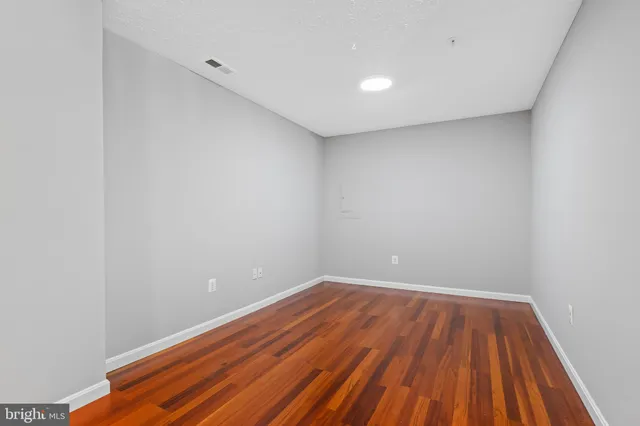 a view of room with wooden floor