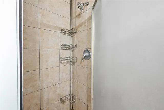 a bathroom with a glass door shower