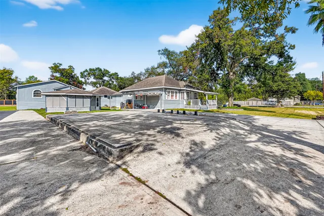 a view of a house with pool and sitting area