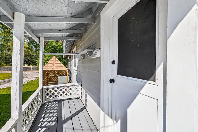a walk in closet with wooden floor and a rug