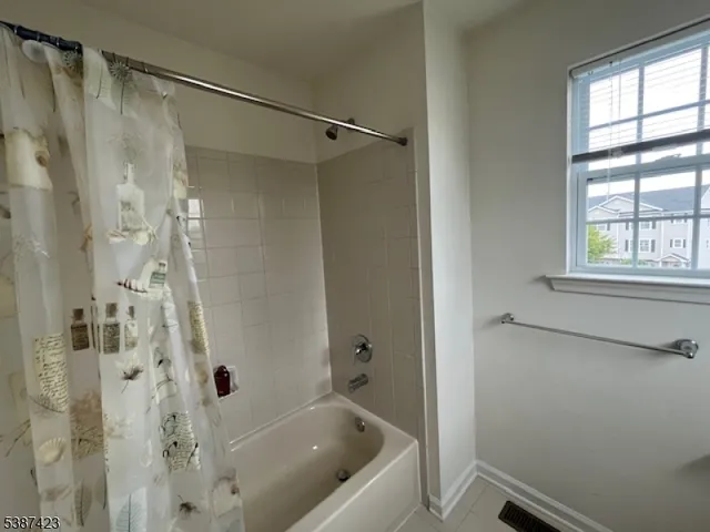 a bathroom with a tub shower and a sink