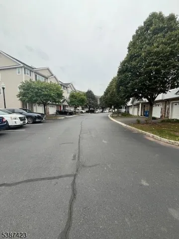 a view of a street with a cars parked
