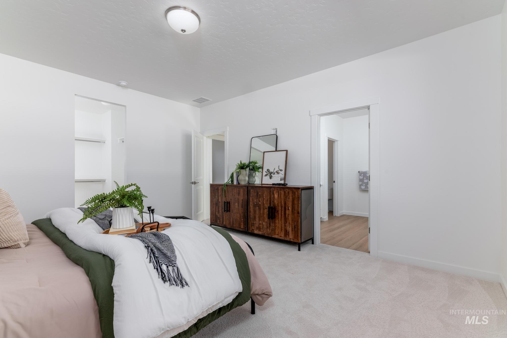14566 Boatwatch Drive Caldwell, ID 83607 - Photo 19 of 42 Bedroom with light colored carpet and a textured ceiling