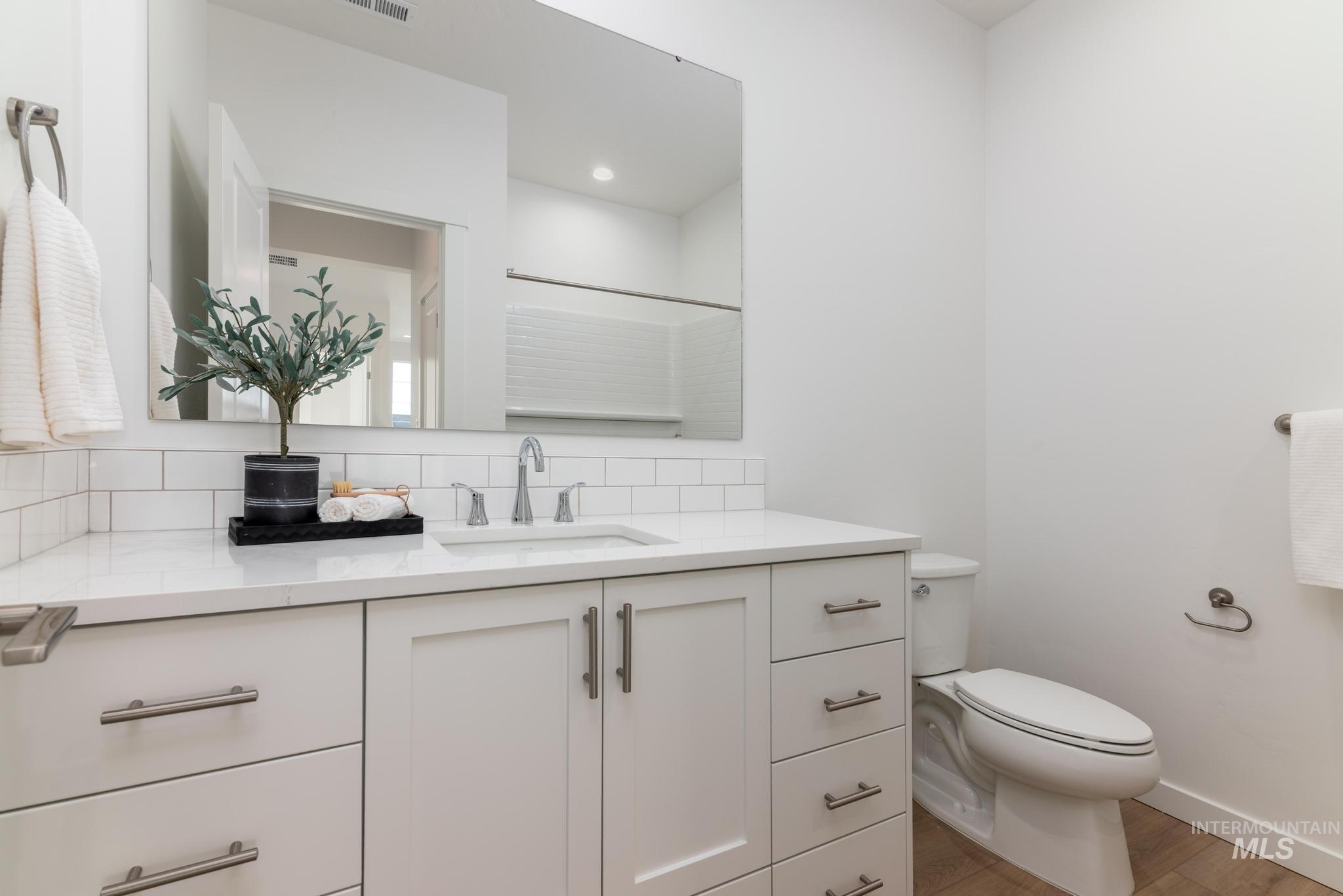 14566 Boatwatch Drive Caldwell, ID 83607 - Photo 26 of 42 Full bathroom featuring vanity, tasteful backsplash, and a shower