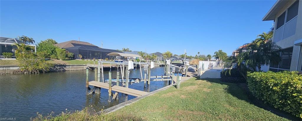 925 Southwest 47th Terrace, Unit 101 Cape Coral, FL 33914 - Photo 13 of 48 a view of a lake with a house in the background
