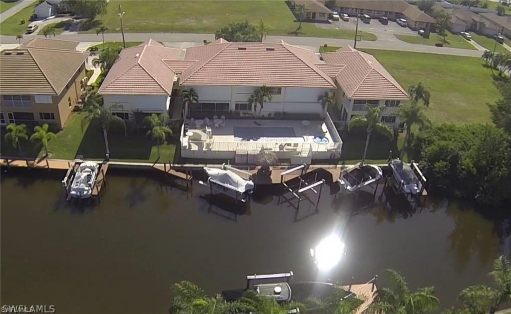 925 Southwest 47th Terrace, Unit 101 Cape Coral, FL 33914 - Photo 19 of 48 an aerial view of residential houses with outdoor space and lake view