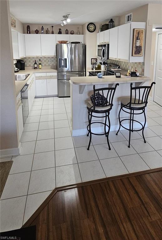 925 Southwest 47th Terrace, Unit 101 Cape Coral, FL 33914 - Photo 21 of 48 a kitchen with a sink and cabinets