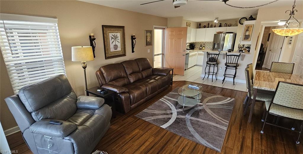 925 Southwest 47th Terrace, Unit 101 Cape Coral, FL 33914 - Photo 24 of 48 a living room with furniture and wooden floor