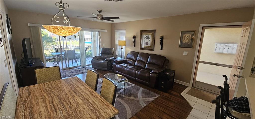 925 Southwest 47th Terrace, Unit 101 Cape Coral, FL 33914 - Photo 25 of 48 a living room with furniture and a chandelier