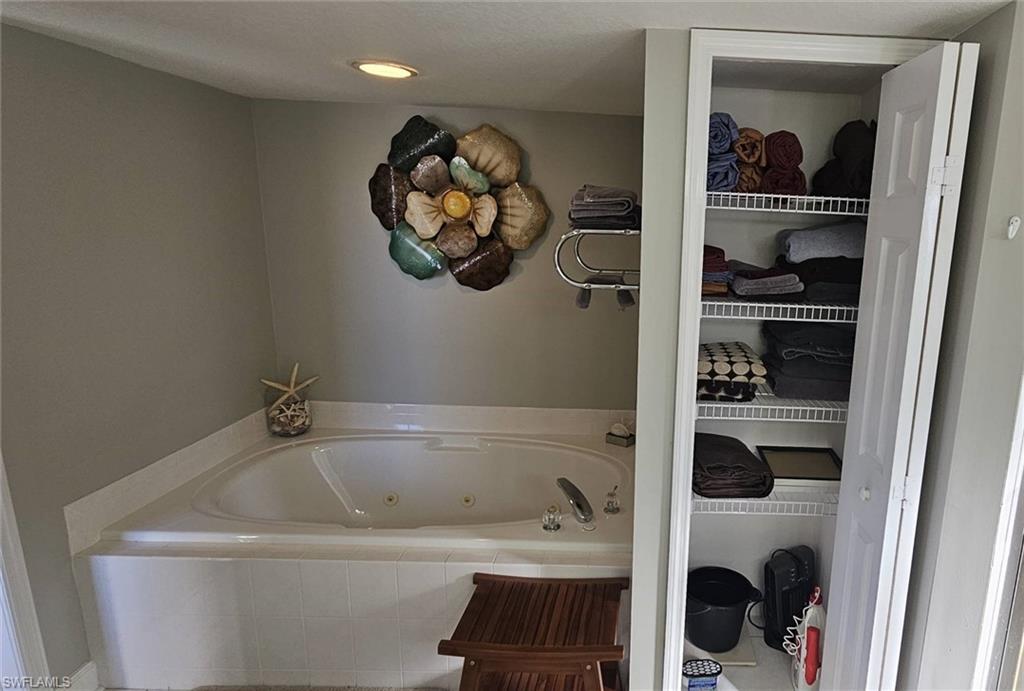 925 Southwest 47th Terrace, Unit 101 Cape Coral, FL 33914 - Photo 36 of 48 a bathroom with a bathtub