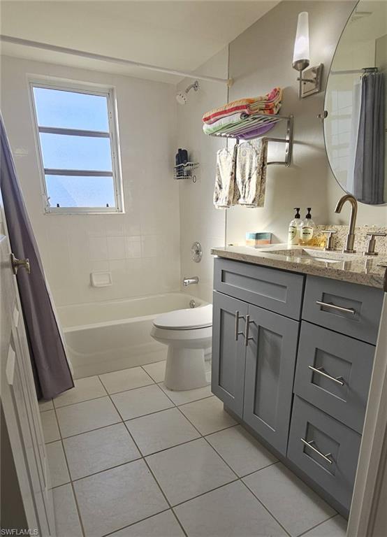 925 Southwest 47th Terrace, Unit 101 Cape Coral, FL 33914 - Photo 45 of 48 a spacious bathroom with a double vanity sink a toilet and a mirror