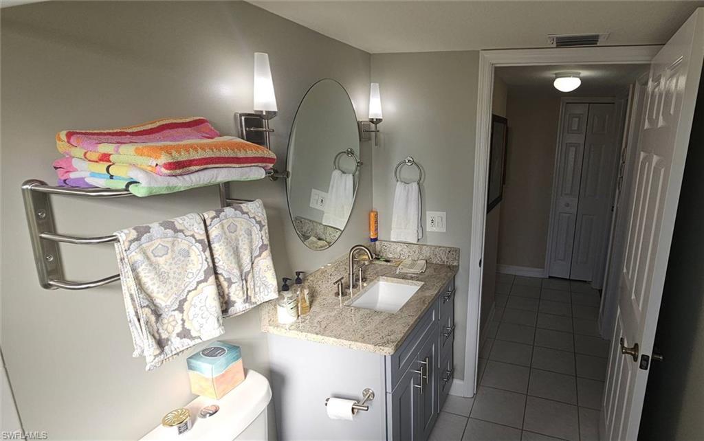 925 Southwest 47th Terrace, Unit 101 Cape Coral, FL 33914 - Photo 46 of 48 a bathroom with a sink vanity and mirror