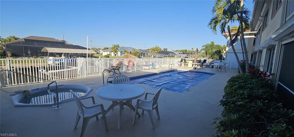 925 Southwest 47th Terrace, Unit 101 Cape Coral, FL 33914 - Photo 8 of 48 a view of a patio with furniture and a yard