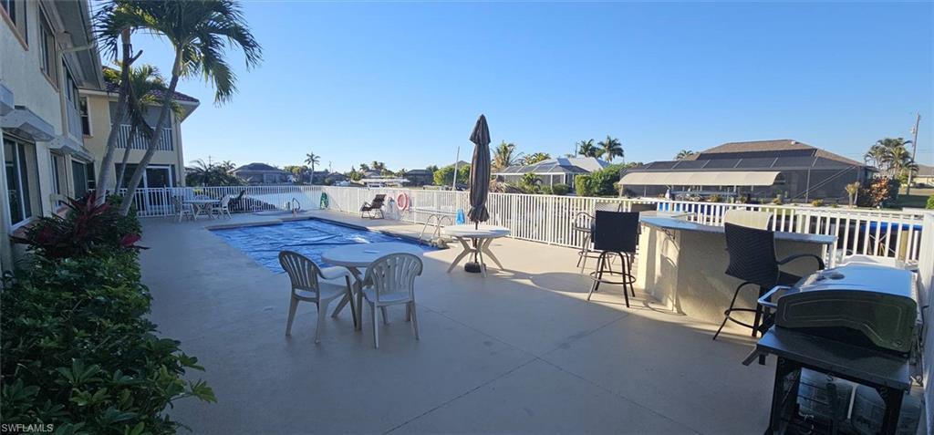 925 Southwest 47th Terrace, Unit 101 Cape Coral, FL 33914 - Photo 10 of 48 a view of a terrace with furniture and a table