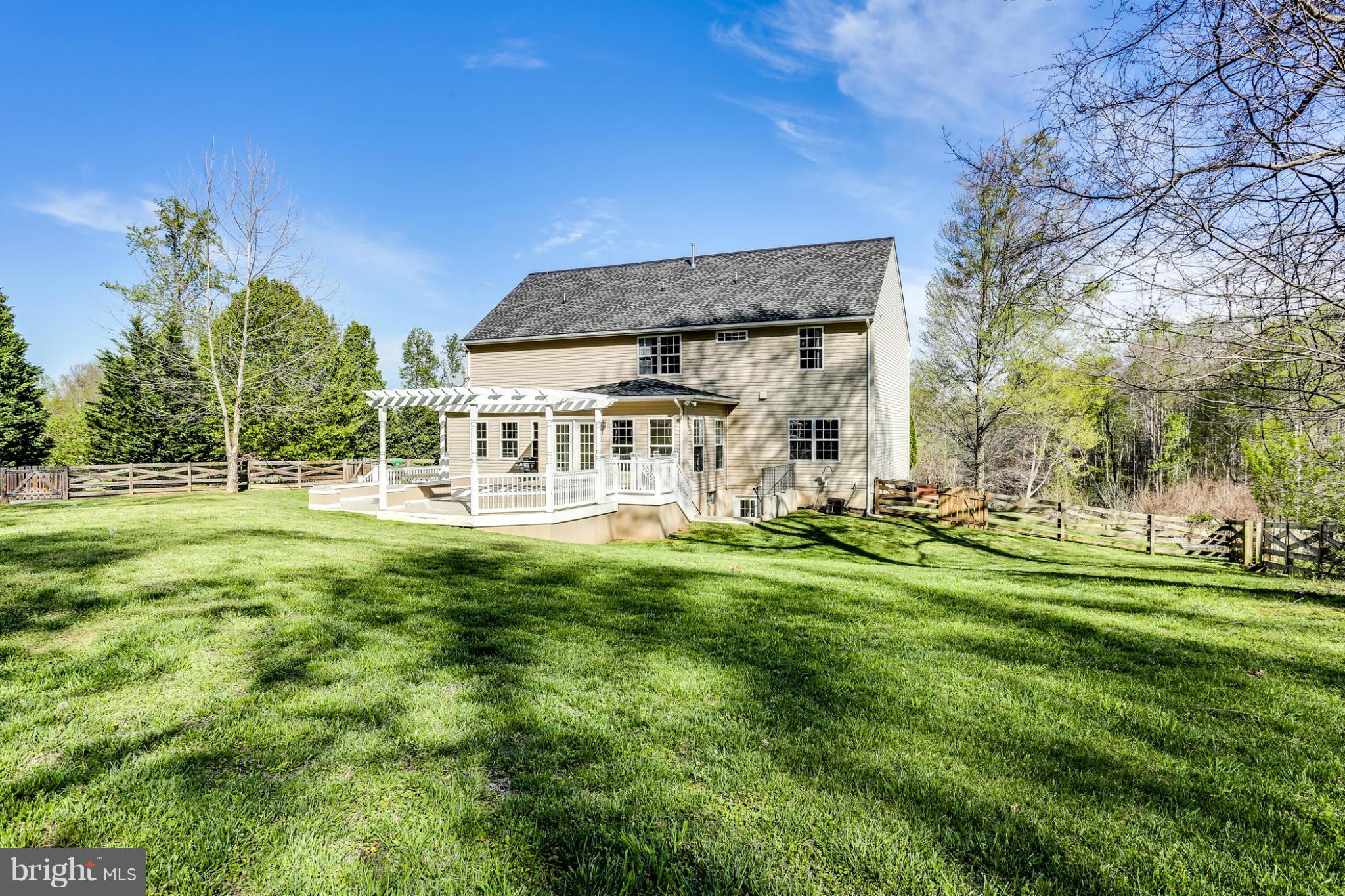 6814 North Stuart Road King George, VA 22485 - Photo 2 of 30 a view of a house with a big yard and garden